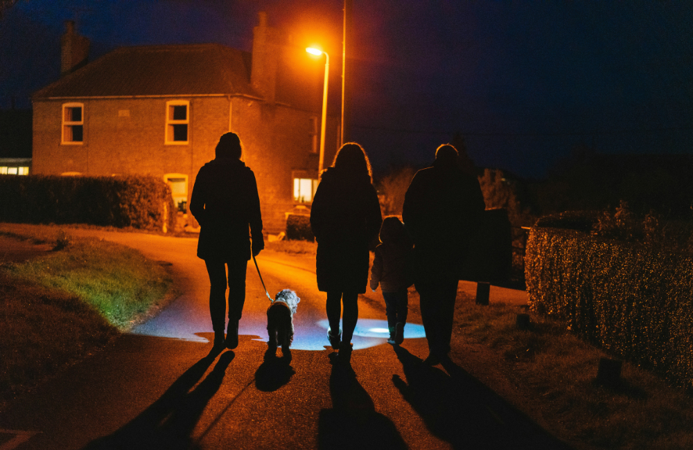 family walking dog at night