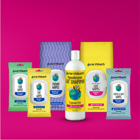 Collection of Earthbath pet care products on a pink background