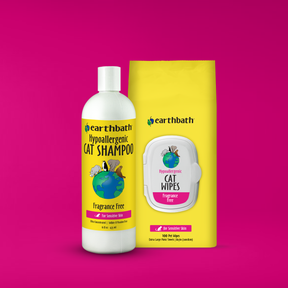 Earthbath cat shampoo bottle and wipes on a pink background