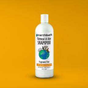 Earthbath Oatmeal & Aloe Shampoo bottle on an orange background