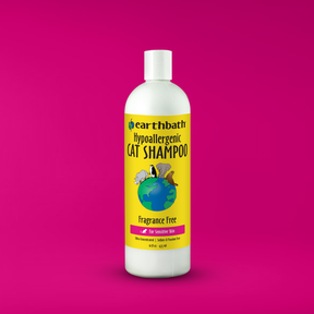Bottle of Earthbath hypoallergenic cat shampoo on a pink background