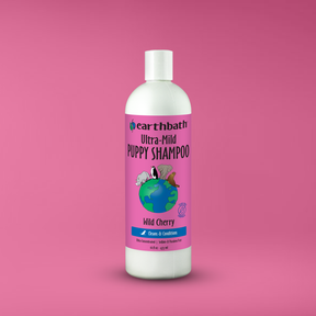 Earthbath Ultra-Mild Puppy Shampoo bottle on a pink background