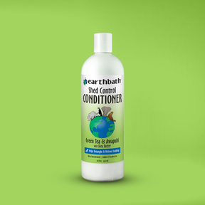 Bottle of Earthbath Shed Control Conditioner on a green background